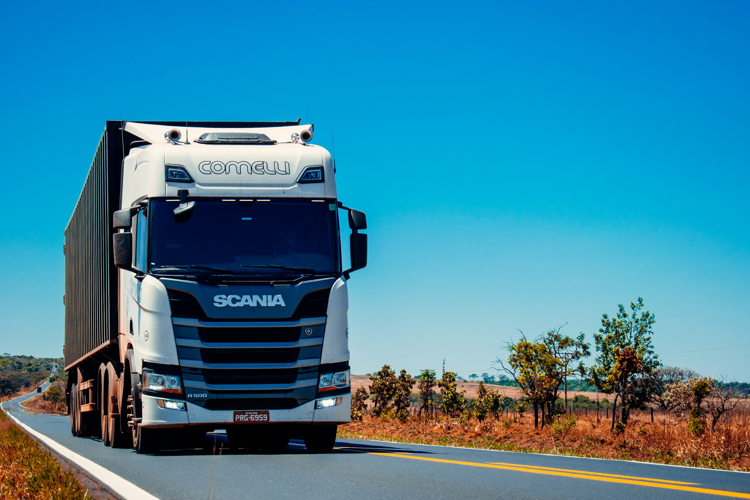 Blue semi truck hauling freight on a highway